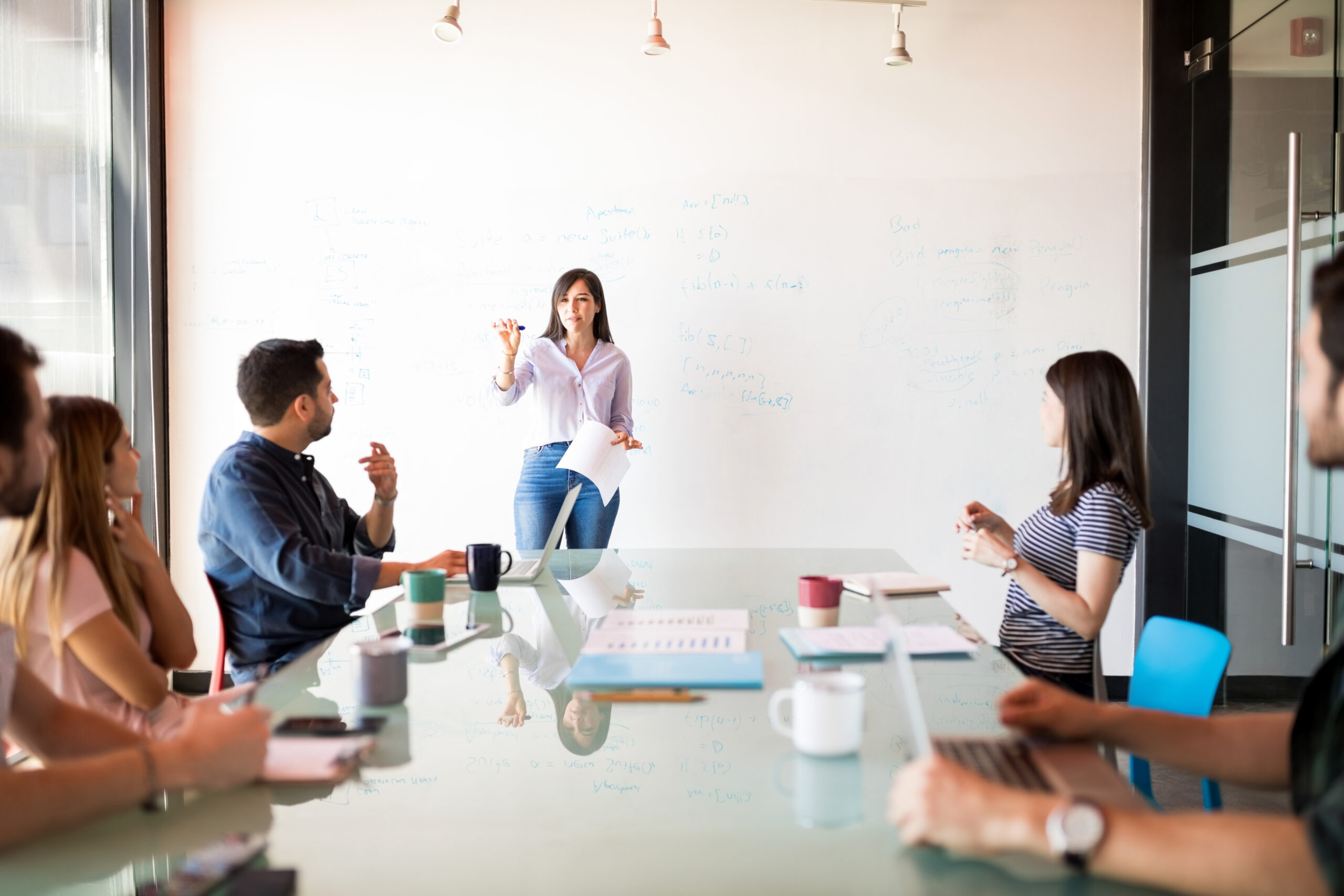 A woman having a presentation on how to write a sales pitch to her colleagues.