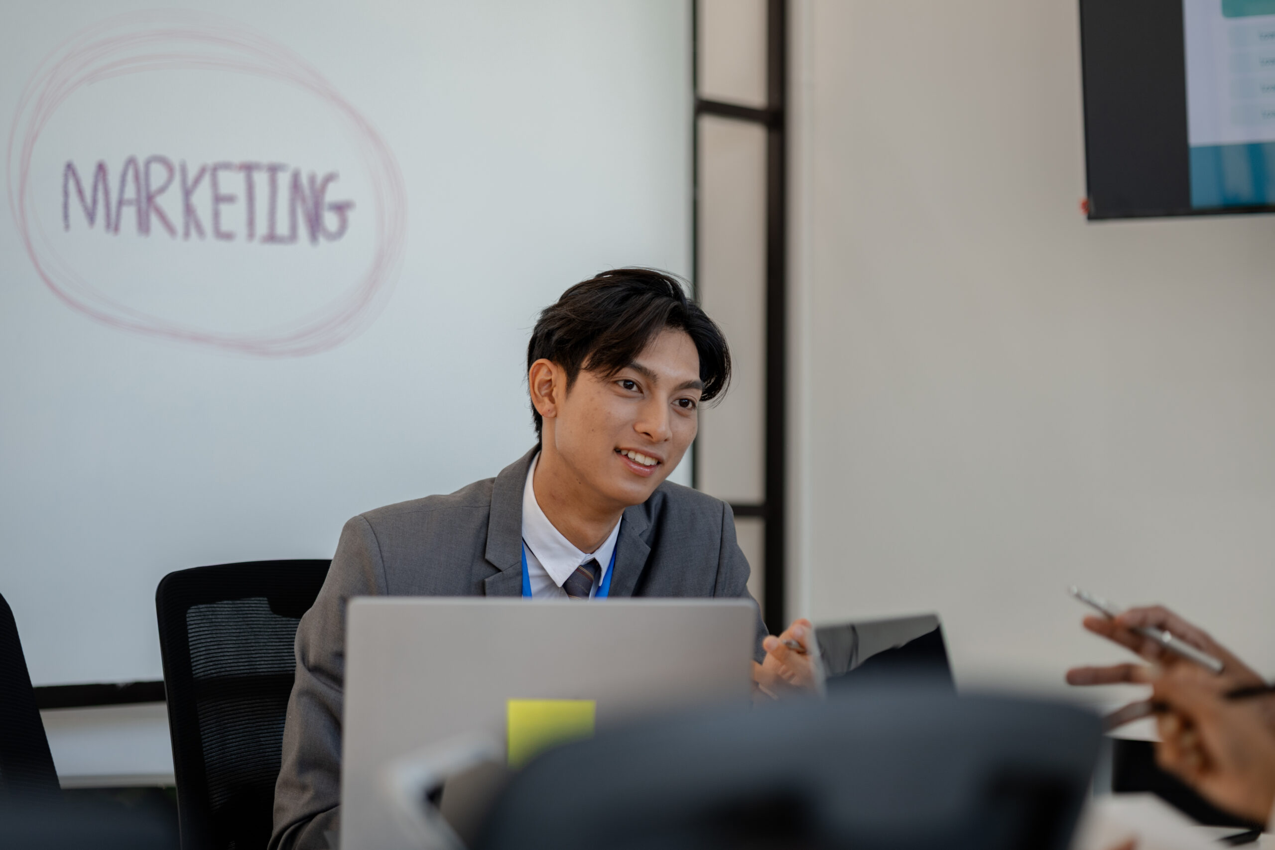 A young professional discussing strategy, showcasing real-world marketing jobs in action.