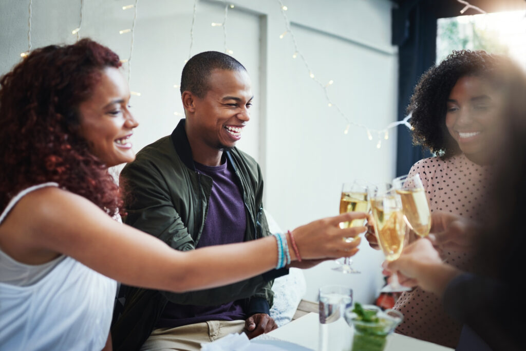 Business professionals connecting over drinks and conversations, highlighting the impact of event marketing.