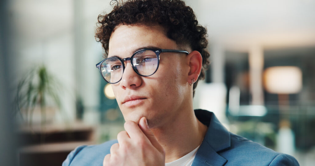 A man resting his chin on his hand while thinking is 99 Exposure Legit.